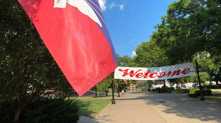 Welcome banner spanning across academic walk on Duqesne's campus.